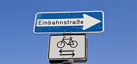 Straßenschild Einbahnstraße und Fahrräder Straßenschild Einbahnstraße und Fahrräder